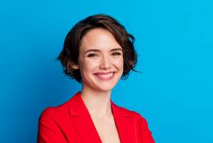 Young brunette woman in a red suit with a short bob haircut